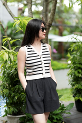 a lady in a striped knit vest cardigan